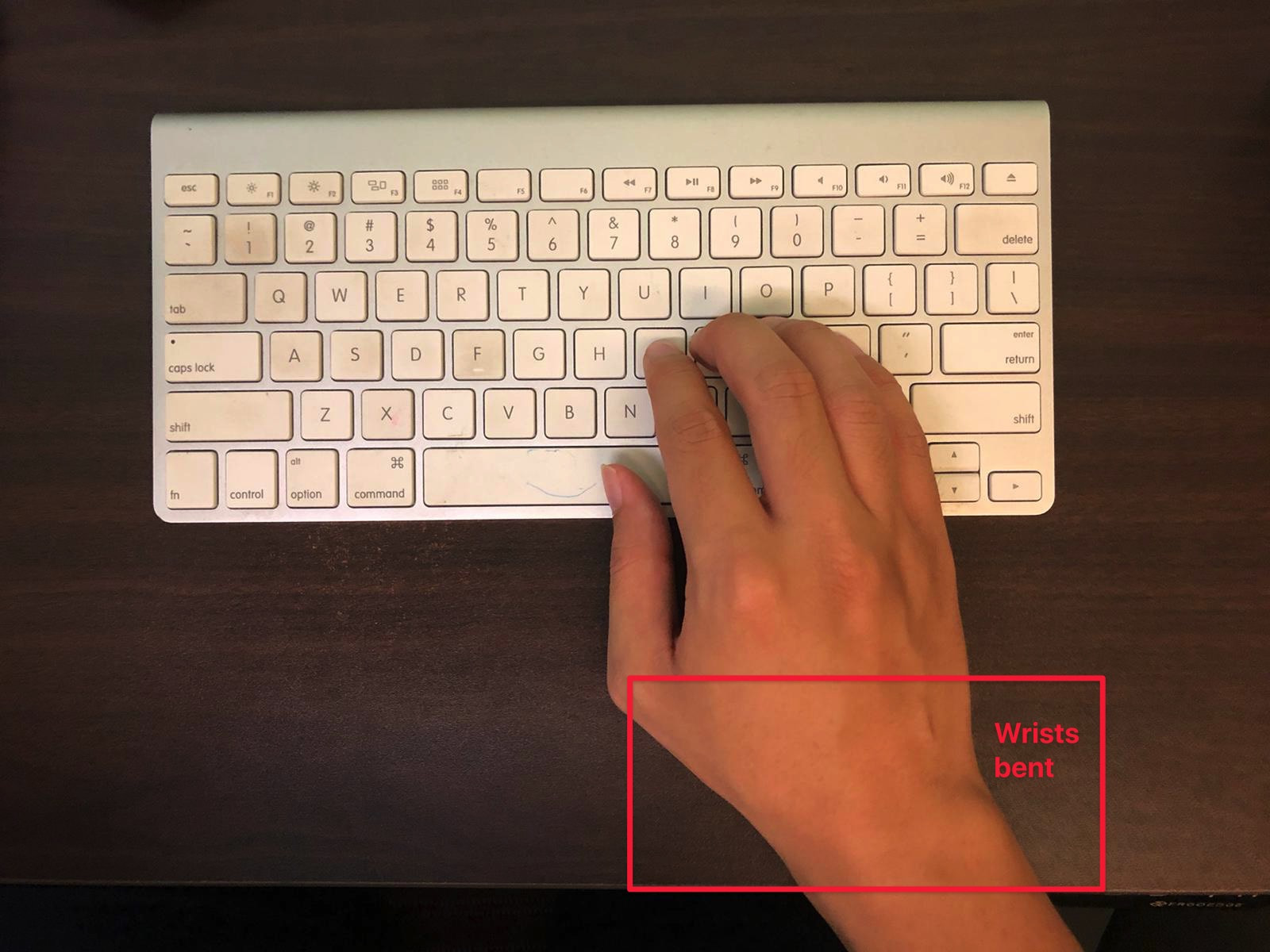 Wrists bent to accommodate the keyboard